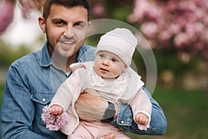 Happy young father walk with his little daughter. Dad hold little baby on hands