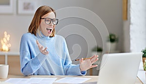 Excited woman woman with laptop screaming photo