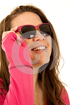 Happy young female model sporting pink sunglasses