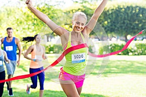 Happy young female runner on finish winning race