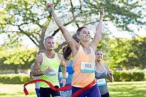 Happy young female runner winning on race finish