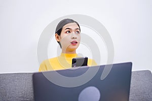 Happy young female surfing the internet shopping online at home after the government announced a ban on leaving the house.,