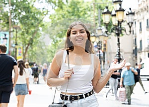Happy young female tourist strolling along La Rambla in Barcelona