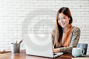 Happy Young Freelancer Woman Working on Computer Laptop in Cozy