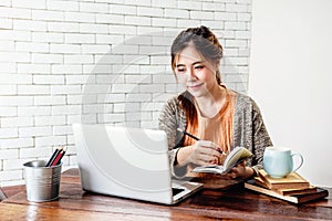 Happy Young Freelancer Woman Working on Computer Laptop in Cozy photo