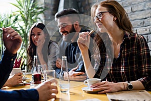 Happy young friends hangout in coffee shop