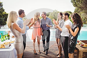 Happy young friends having drinks