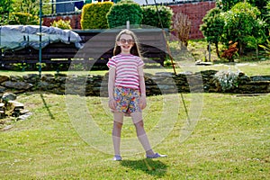 Happy young girl on the beach at Tighnabruaich in Argyll and Bute on the west coast of Scotland during the summer