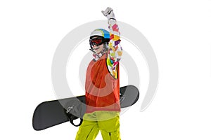 Happy young girl in bright sportswear, goggles and helmet standing with snowboard isolated on white studio background