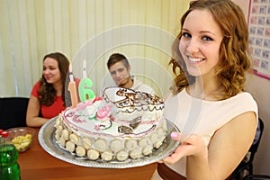 Happy young girl with a cake with candles sixteen photo