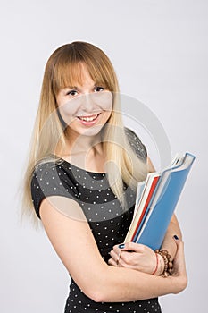 Happy young girl with a folder in his hands happily smiling in the picture