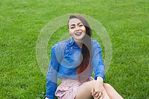 Happy young girl on green grass