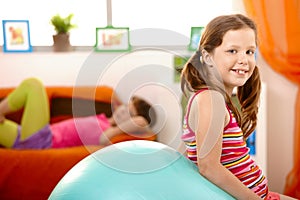 Happy young girl with gym ball