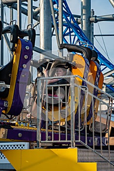 Happy young girl having fun on boardwalk amusement ride