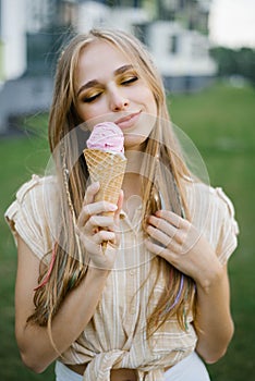 Happy young girl holding ice cream and enjoying a summer day