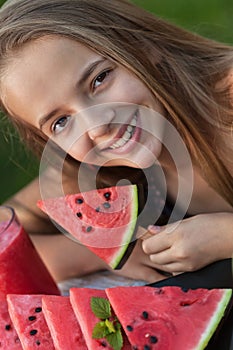 Happy young girl holding watermelon slice - portrait