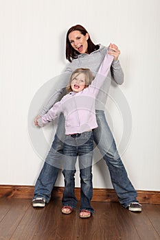 Happy young girl at home celebrating with her mum