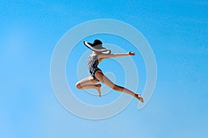 Happy young girl jumping up to the sky. People, happiness, travel concept.