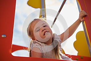 Happy Young Girl Looking out from Play Equipment