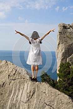 Happy young girl on the rocks