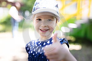 Happy young girl showing thumb up