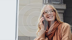 Happy young girl smiling talking on phone bottom view Caucasian female shopper attractive millennial woman laughs