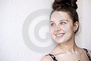 Happy young girl smiling in the window
