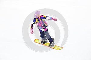 Happy young girl snowboarding on a snow slope