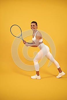 happy young girl in sportswear running with racket. sportswoman. energetic woman