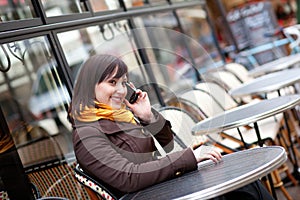 Happy young girl takling on cell phone