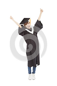 Happy Young graduate girl student standing and hand up