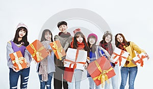 Happy young  group  showing the  gifts and celebrating Christmas festiva and new year holiday