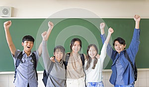 Happy young group of teenagers student having fun  in classroom