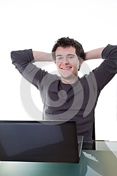 Happy young guy works on his laptop