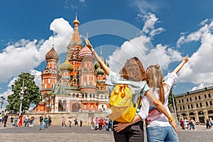 happy young happy girls travels in Russia and taking selfie in front of the St Basil Cathedral