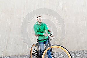 Happy young hipster man with fixed gear bike