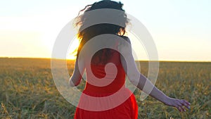 Happy young hispanic beautiful woman running on wheat field in sunset summer. Freedom health happiness tourism travel