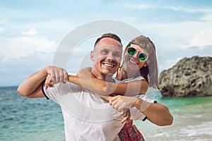 Happy young honeymoon couple having fun on the beach. Ocean, tropical vacation on Bali island, Indonesia.