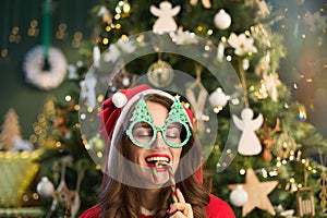 happy young housewife with Santa hat in modern house