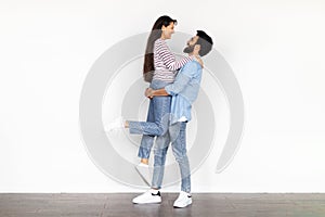 Happy young indian couple celebrating buying new apartment