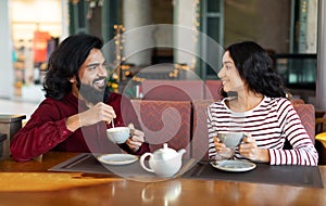Happy young indian couple have romantic date at cafe