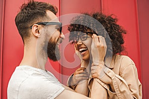 happy young interracial couple in eyeglasses having fun together photo