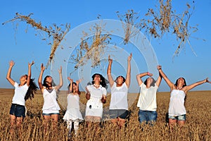 Happy young Israeli women throwing wheat to the air on Shavuot J