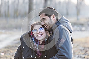 Happy young joyful couple having fun moments and laughing together in autumn season