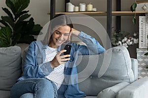 Happy young lady calling friend by video link chatting joking