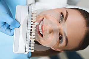 Smiling woman is choosing veneers stock photo photo