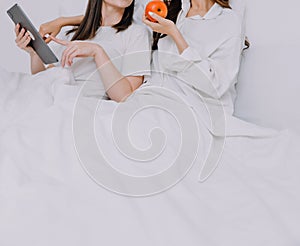 Happy young lesbian couple taking selfie together, Couple of friends relaxing and spending time on weekend at home, Couple of