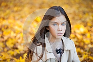 Happy young little girl in beige coat