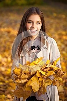 Happy young little girl in beige coat