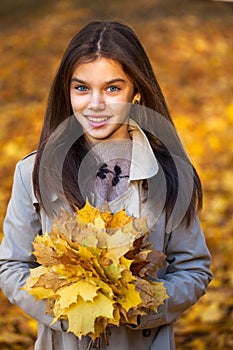 Happy young little girl in beige coat